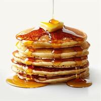 a stack of pancakes covered in syrup and butter photo