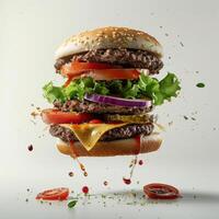a hamburger flying through the air with lettuce, tomato, onion, and cheese photo