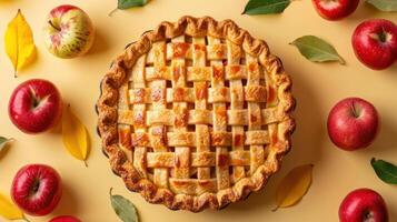 an apple pie surrounded by apples and leaves photo