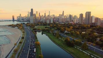 Sunset over Chicago skyline with river view, The sun sets behind Chicago's towering skyscrapers, casting a warm glow over the city's iconic skyline and illuminating the river flowing through the urban video