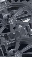 A close-up perspective showcases a series of rotating interlocking metal gears, highlighting the precise engineering and the complexity of mechanical design in machinery. vertical footage video