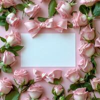 Delicate pink roses and bows surrounding a blank square, perfect for invitations or messages photo