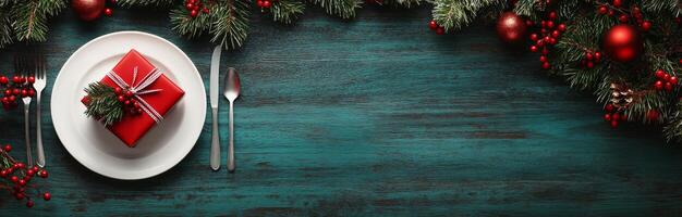 Christmas table setting with a red gift, festive decorations, and holiday cheer on a wooden surface photo