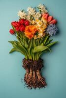 Colorful spring flowers and gardening tools arranged artistically against a vibrant blue background photo