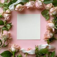 A serene arrangement of pink roses framing a blank card with white bows on a soft background photo