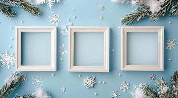 Three White Frames With Snowy Pine Branches On Blue Background photo