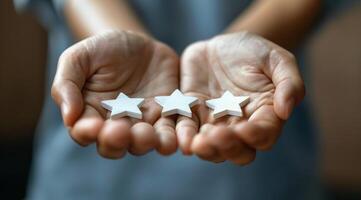 Person Holding Two Gold Stars photo