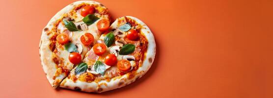 Heart-Shaped Pizza Topped With Fresh Tomatoes and Basil on a Orange Background photo