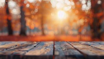 Autumn Sunset Over a Wooden Table Surrounded by Colorful Fall Foliage photo