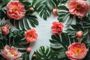 A vibrant arrangement of lush green leaves and coral peonies on a light background photo