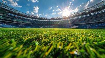 Bright sunlight over a vibrant green grass field in a large stadium during the afternoon photo