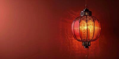 Beautiful red Chinese lantern hanging in a decorated room with ornate wall and trim details photo