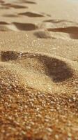 Footprints in golden sand at a tranquil beach during a sunny afternoon photo