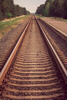 The old railway sleepers and rails extending into the distance photo