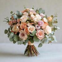 Elegant bouquet of soft pink and cream roses with eucalyptus leaves arranged for special occasions photo