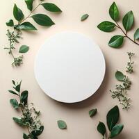 A round white plate surrounded by various green leaves and shapes on a light background photo