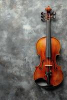 A beautifully crafted violin rests against a textured gray background with elegant detailing photo