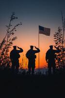 Soldiers saluting the American flag at sunset in a patriotic display of honor and respect photo