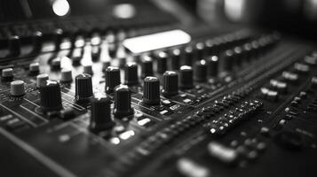 A close up view of an audio mixing console with various knobs and sliders in a studio setting photo