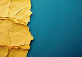 Textured yellow paper against vibrant blue background creating visual contrast and interest photo