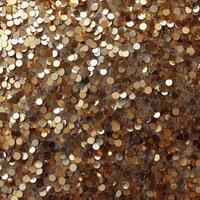 Shimmering golden sequins arranged together creating a sparkling texture on a surface photo