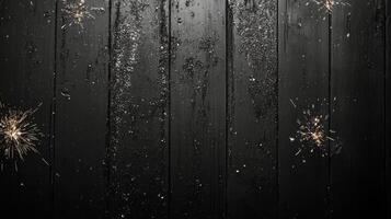 A dark wooden surface adorned with shimmering golden sparks during a festive celebration photo