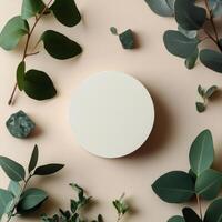 A round white plate surrounded by various green leaves and shapes on a light background photo