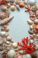 A beautiful arrangement of seashells and coral with a textured blue background photo