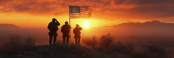 Three soldiers stand on a hillside, saluting while holding an American flag during a stunning sunset photo