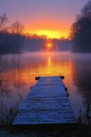 Early morning tranquility at a misty lake with a wooden dock reflecting dawn colors photo