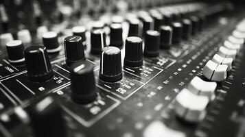 A close up view of an audio mixing console with various knobs and sliders in a studio setting photo