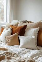 Cozy bedroom setting with colorful pillows and a warm atmosphere during the day photo