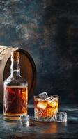 A glass and bottle of whiskey next to a wooden barrel on a dark textured background photo