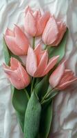 Fresh pink tulips with dew droplets arranged elegantly in a bouquet for spring decor photo