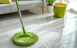 Cleaning a living room floor with a mop and bucket during the morning hours on a sunny day photo