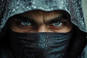 Mysterious figure with intense gaze dressed in rain soaked dark attire in an urban environment photo