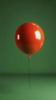 A single red balloon floats gracefully against a simple green backdrop in a quiet indoor setting photo