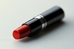 Bright red lipstick tube placed on a light surface with a minimalist design in a stylish setting photo