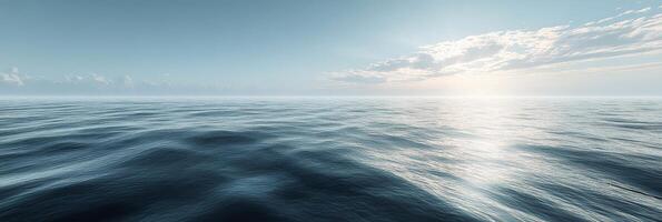 Serene view of calm ocean waters under a bright sky at dawn with subtle waves reflecting sunlight photo