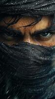 Close up of a mysterious figure with intense eyes wearing a dark cloth in a rainy environment photo