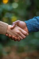 Two hands shaking in a gesture of friendship and agreement, conveying unity and cooperation photo