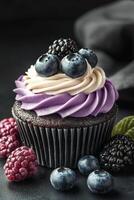Delicious cupcake topped with cream and berries on a dark surface, perfect for dessert lovers photo