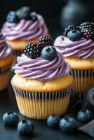 Delicious cupcake topped with cream and berries on a dark surface, perfect for dessert lovers photo
