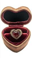 Elegant heart shaped ring box with a ruby and diamond engagement ring inside it photo
