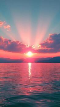 A beautiful sunset over a tranquil lake with vibrant colors and mountainous backdrop photo