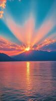 A beautiful sunset over a tranquil lake with vibrant colors and mountainous backdrop photo