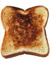 Toasted bread slice with unique burn design on a white background capturing warmth and texture photo