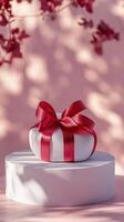 Decorative pink gift box with a heart ribbon in a bright room during daytime photo