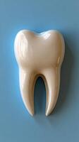 A large ceramic tooth sculpture displayed against a light blue background in a dental office photo
