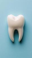 A large ceramic tooth sculpture displayed against a light blue background in a dental office photo
